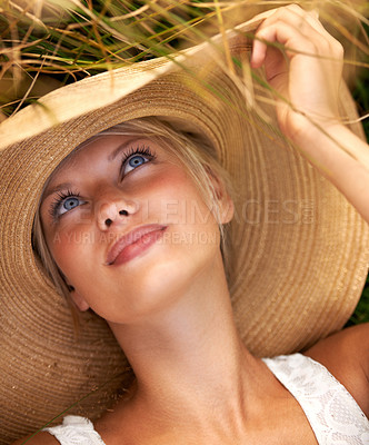 Buy stock photo Wheat, hat and relax with woman in field for travel, vacation and holiday. Thinking, peace and nature with female person and grass in countryside meadow for calm environment, spring and sunshine