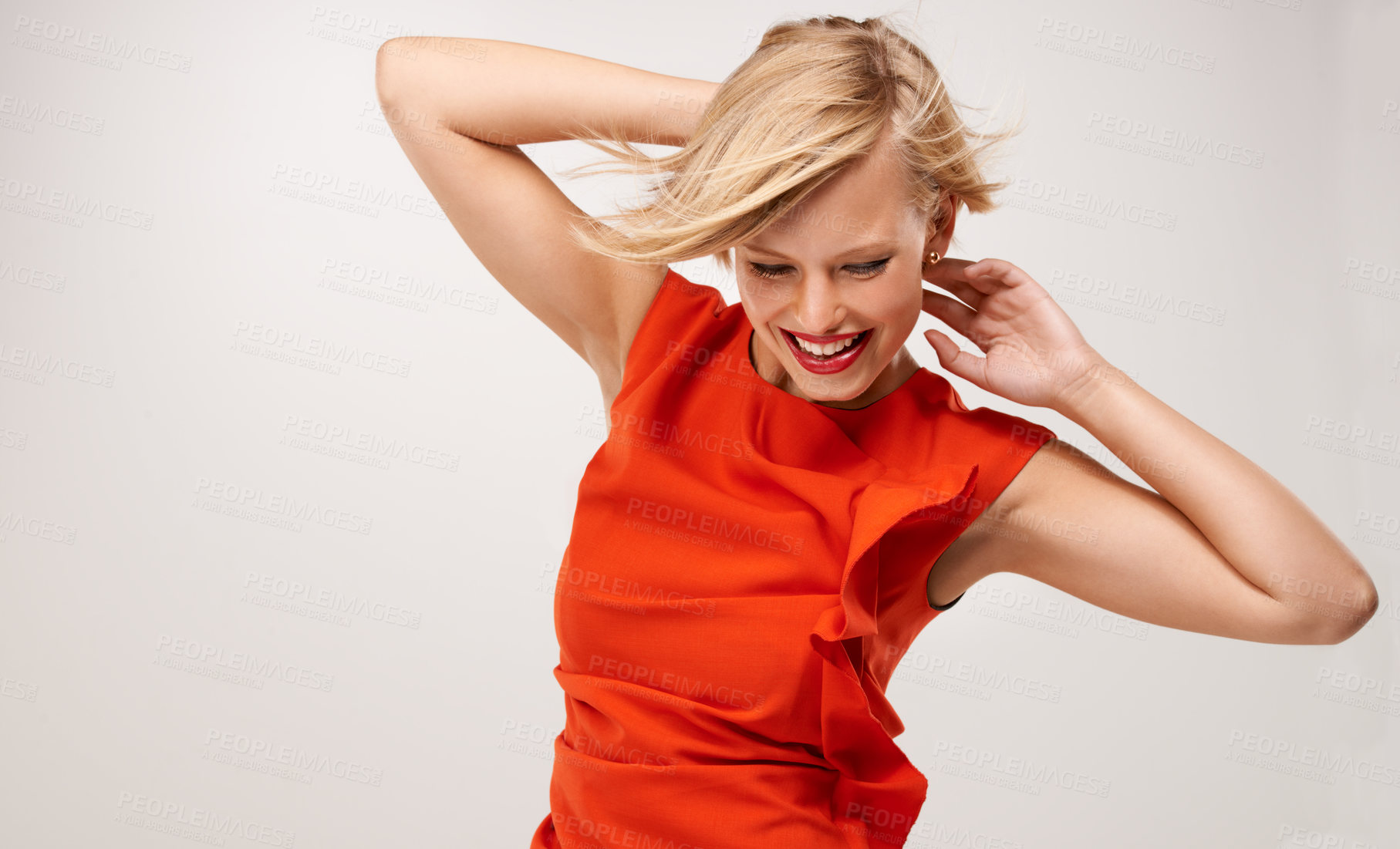 Buy stock photo An attractive young woman wearing a red dress