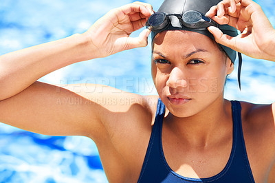 Buy stock photo Portrait, woman and athlete swimming with goggles for challenge, water sports and training. Serious swimmer at pool in sunshine for performance, exercise and ready for contest, competition and race 