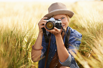Buy stock photo Field, photographer and woman with a camera, portrait with nature, travel and memory with sunshine. Person, countryside or face with photography, outdoor and journey with adventure, picture or summer