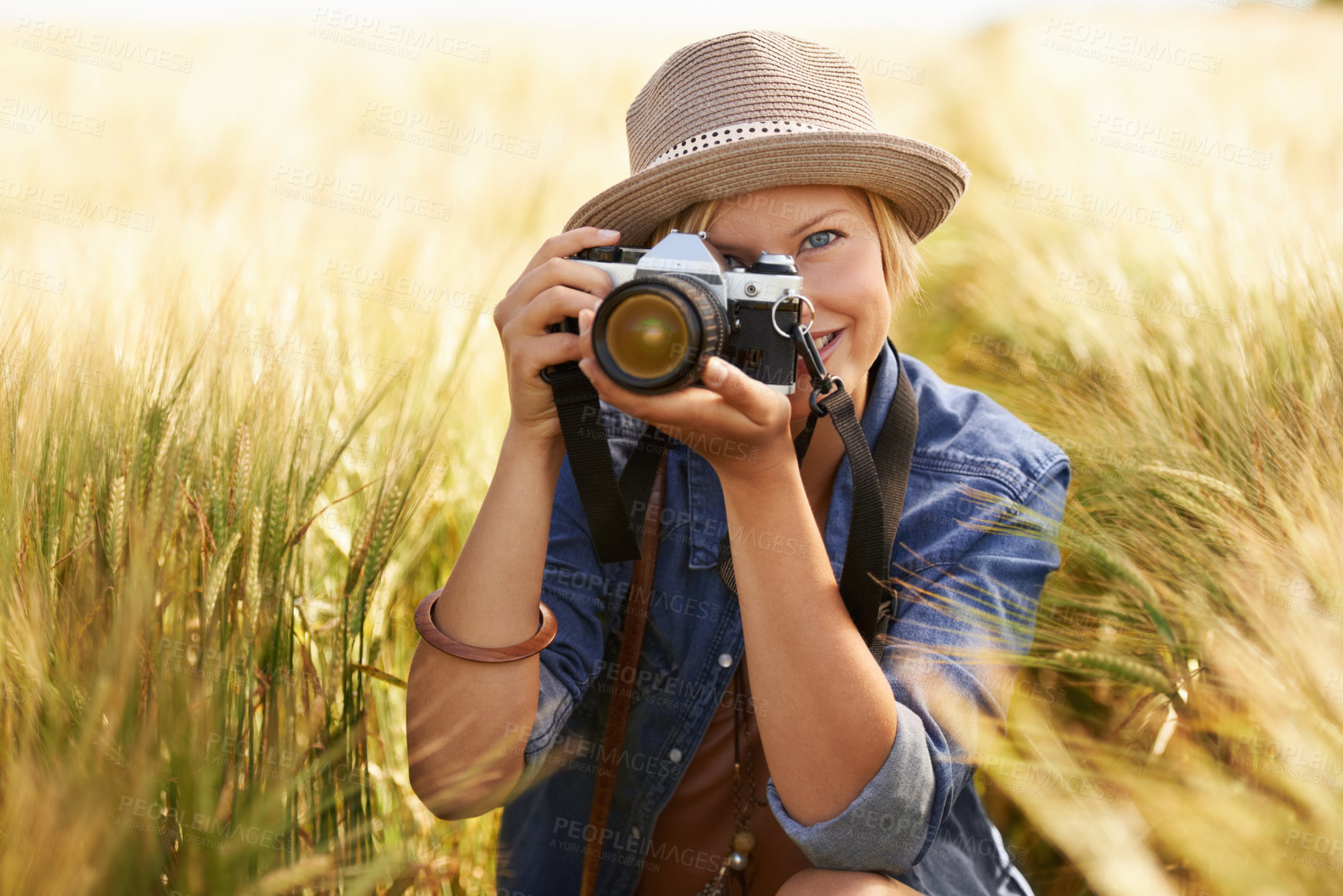 Buy stock photo Field, photographer and woman with a camera, portrait with nature, travel and memory with sunshine. Person, countryside or face with photography, outdoor and journey with adventure, picture or summer