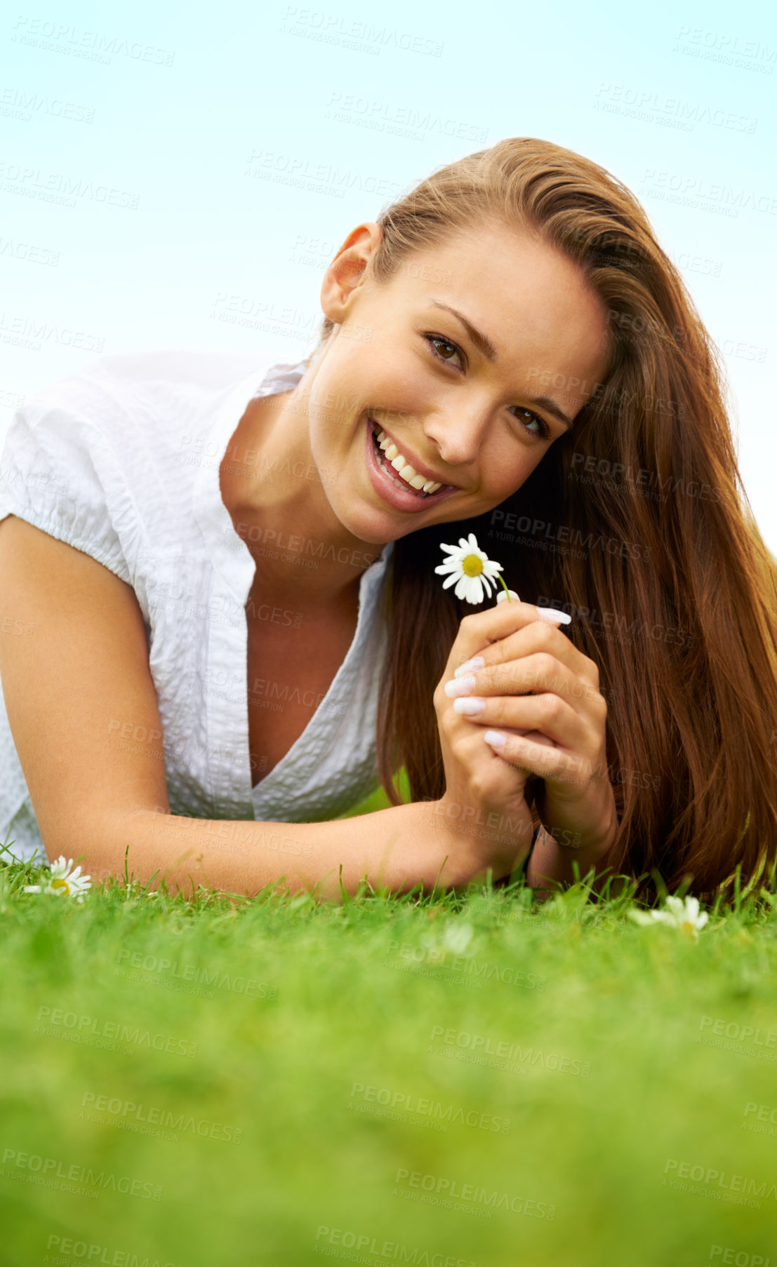 Buy stock photo Portrait, happy and woman with daisy on grass, lying down on field and enjoying spring on vacation outdoor. Smile, flower plant and beauty of female person relaxing, mockup and having fun in nature.