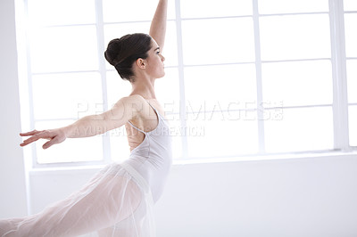 Buy stock photo Dance, ballet and window with woman in studio for balance, elegant and performance. Artist, theatre and training with female ballerina dancing in class for competition, freedom and commitment