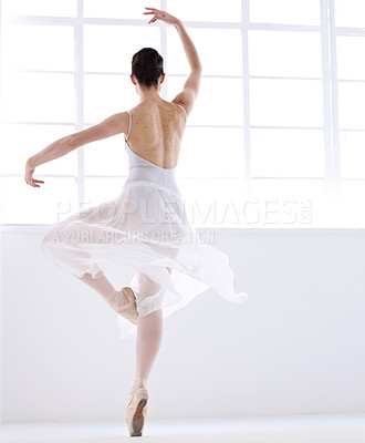 Buy stock photo Dance, ballet and creative with woman in studio for balance, elegant and performance. Artist, theatre and training with female ballerina dancing in class for competition, freedom and commitment