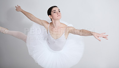 Buy stock photo Focus, dance and ballet with a woman in studio on a white background for rehearsal or recital for theatre performance. Art, creative and balance with an elegant young ballerina or dancer in uniform