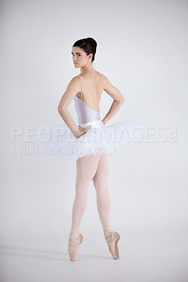 Buy stock photo Portrait, dance and ballet with a woman in studio on a white background for theatre performance rehearsal or recital. Art, creative and back with a young ballerina or dancer standing hands on hips