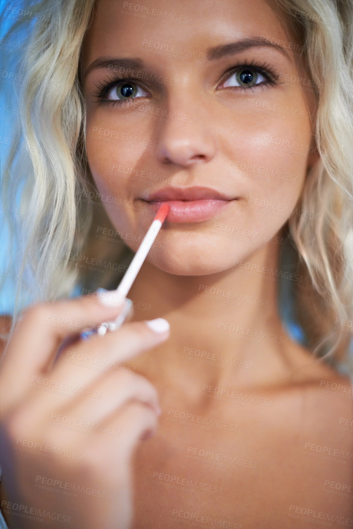 Buy stock photo Pretty young woman putting on some lipgloss
