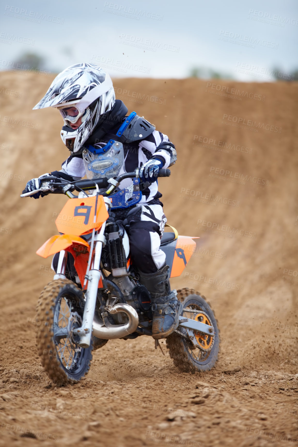 Buy stock photo Motorcycle, sports and a child rider on a dirt track for racing, adventure or adrenaline outdoor during a hobby. Fitness, children and freedom with a boy kid on a bike for speed training or challenge