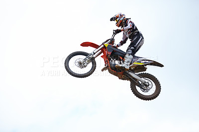 Buy stock photo Person, motorcycle and air jump adventure as professional in action, competition or fearless. Bike rider, off road transportation stunt or fast speed blue sky or rally, extreme sport or challenge
