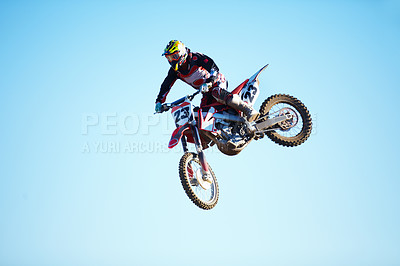 Buy stock photo Person, motorcycle and jump adventure in blue sky as professional in action, competition or fearless. Bike rider, off road race or air stunt for speed driving at rally, extreme sport or challenge