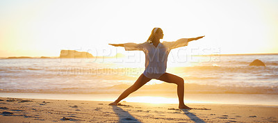 Buy stock photo Tranquil scene of a young woman doing a pilates pose on the beach at sunset