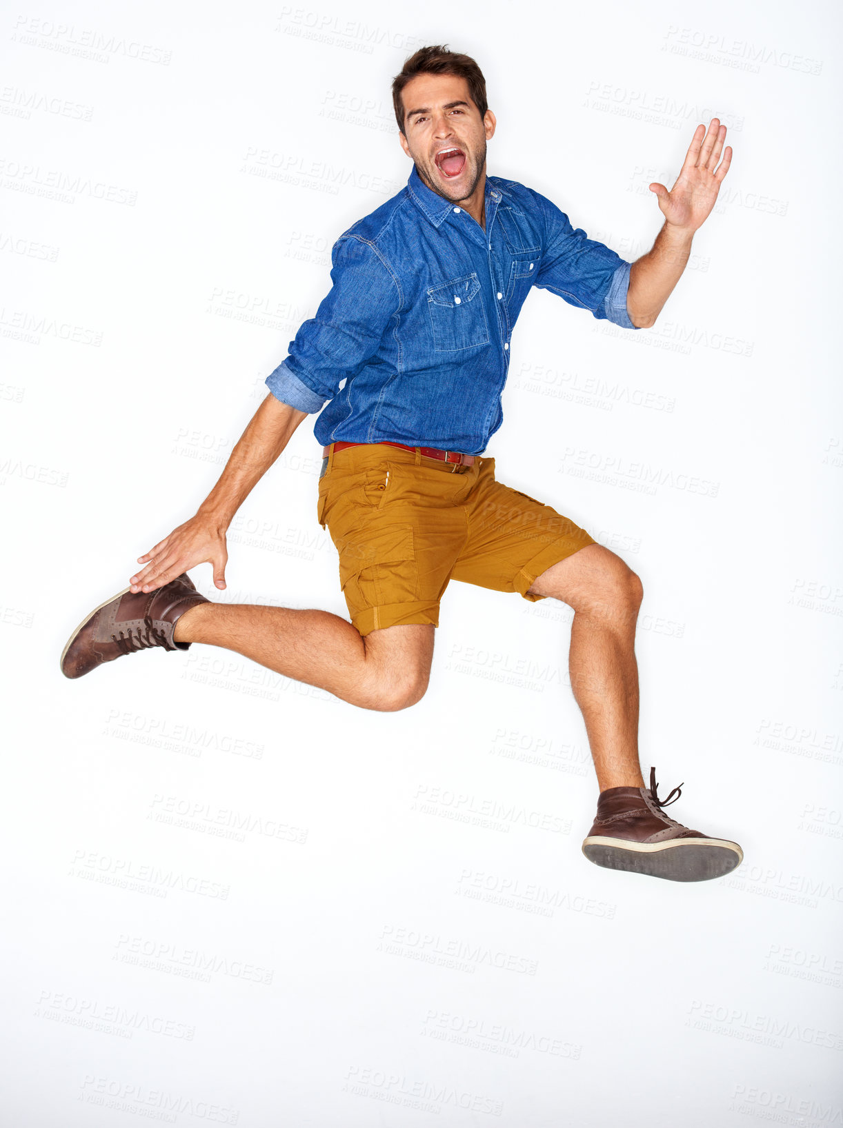 Buy stock photo Portrait, fashion and energy with a man jumping in studio on a white background for trendy hipster fashion. Success, winner and leap for motivation with a young model shouting in a clothes outfit