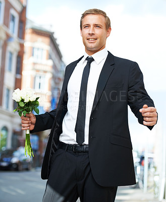 Buy stock photo Man, gift and valentines day flowers or roses on a city street for a date, love and motivation. Model person in a formal suit with a flower bouquet to celebrate holiday or event with urban travel