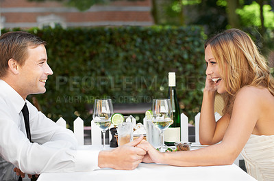 Buy stock photo Love, romantic and happy couple on a date at a restaurant for anniversary, valentines day or romance event. Happy, smile and woman holding hands at an outdoor dinner with her husband in the city.