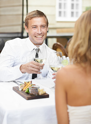 Buy stock photo Love, toast and wine with couple at restaurant for food, valentines day and celebration. Champagne, fine dining and relax with happy man and woman at table flirting for smile, marriage and date