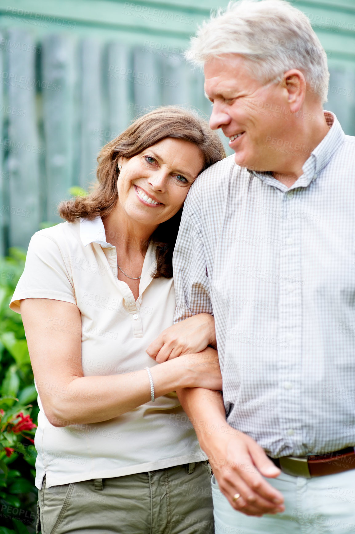 Buy stock photo Senior couple, arm or love with support in marriage, care or wife smile on face in commitment family security. France, mature man or woman with gratitude, embrace or happy together in garden backyard