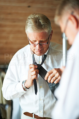 Buy stock photo Senior man with mirror, tie and shirt for work in morning in apartment with glasses, clothes and confidence. Face, reflection and professional mature businessman in home getting ready for office.