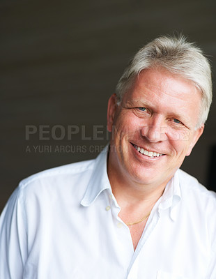Buy stock photo Cropped portrait of a senior man against a dark background
