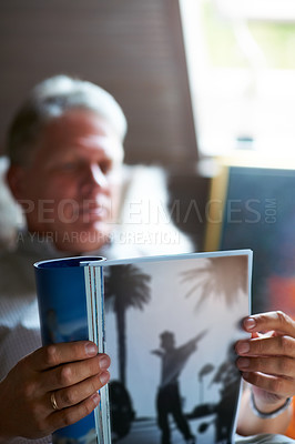 Buy stock photo Relax, magazine or mature man reading newspaper articles in home for information or story updates. Blur, book or senior person studying abstract art for knowledge in a publication in living room