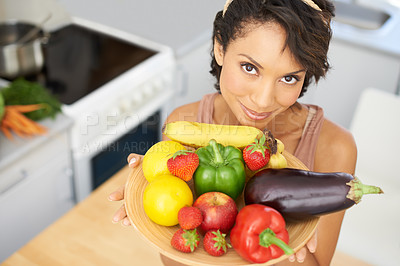 Buy stock photo Portrait, health and vegetables with a woman in the kitchen of her home for nutrition, diet or meal preparation. Face, ingredients and a recipe for cooking food with a young person in her apartment