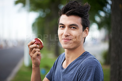 Buy stock photo Man, smile and eating an apple, health and wellness in portrait, nutrition and vitamins for vegan. Happy male person, fruit and organic or natural, breakfast and diet in outdoors, fresh and digestion