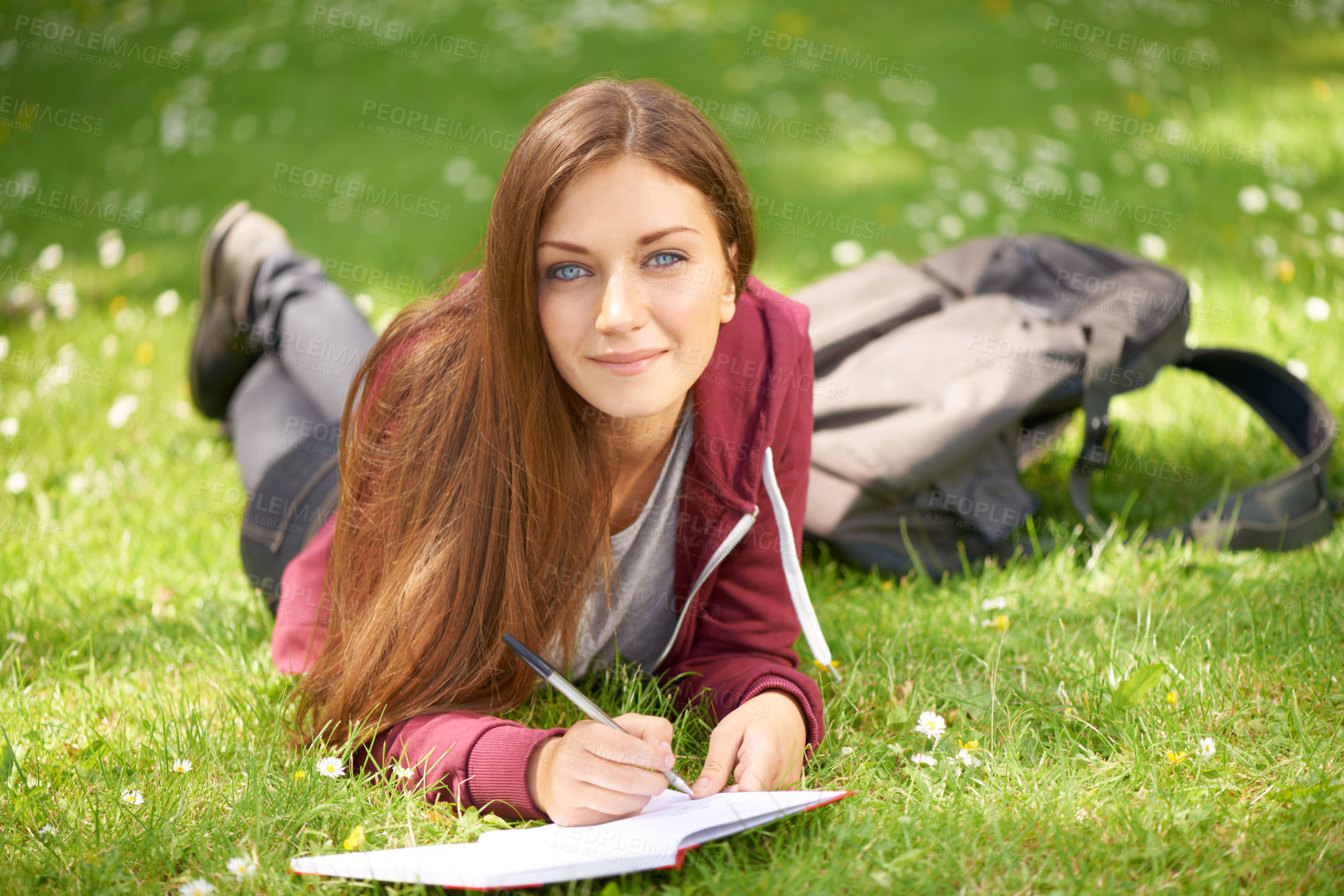 Buy stock photo Woman, student and grass for writing, portrait or planning at university, campus or park for studying. Girl, book and pen for education, learning or brainstorming ideas on lawn at college in sunshine