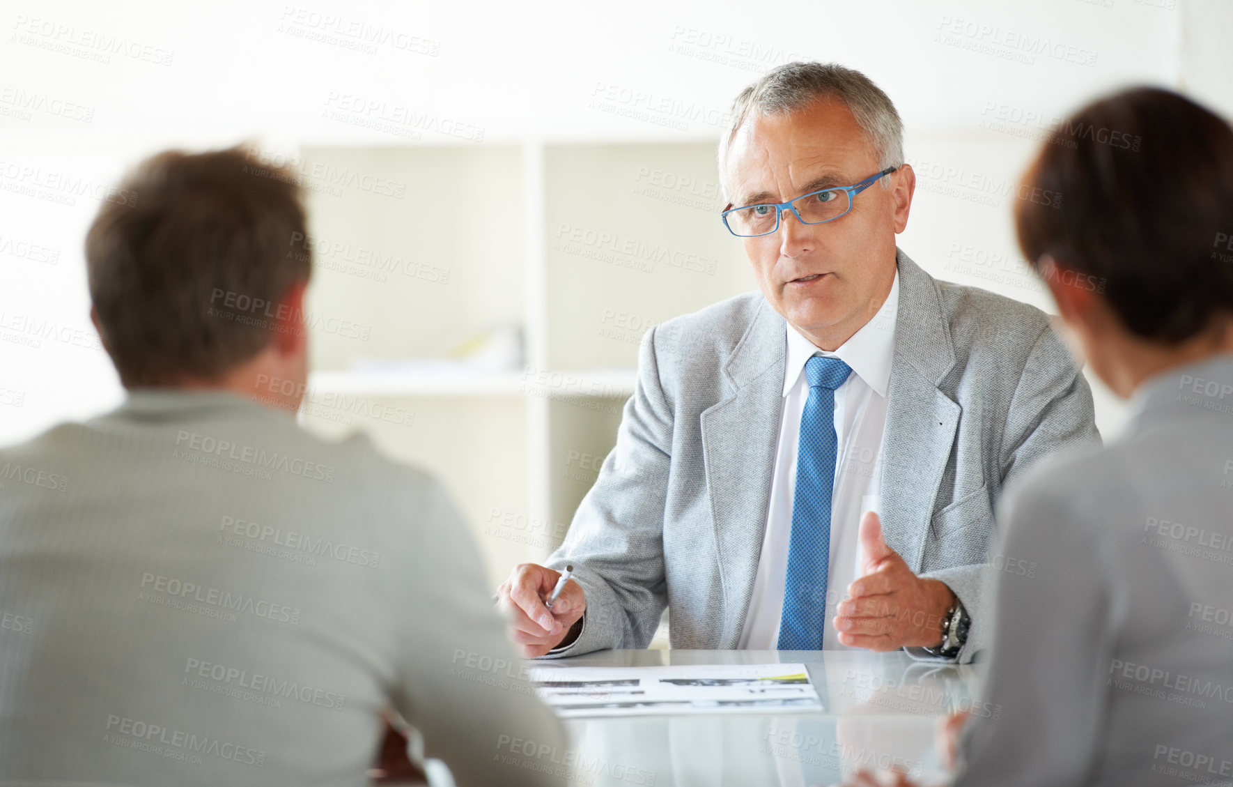 Buy stock photo Man, leader and discussion at business meeting, conversation and feedback or review in training. Mature businessman, employees and communication in workshop, agenda and planning for future growth