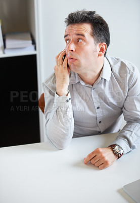 Buy stock photo Phone call, thinking or waiting with a business man sitting at his desk in the office for work. Time, contact and communication with an impatient young employee talking on his mobile in the workplace