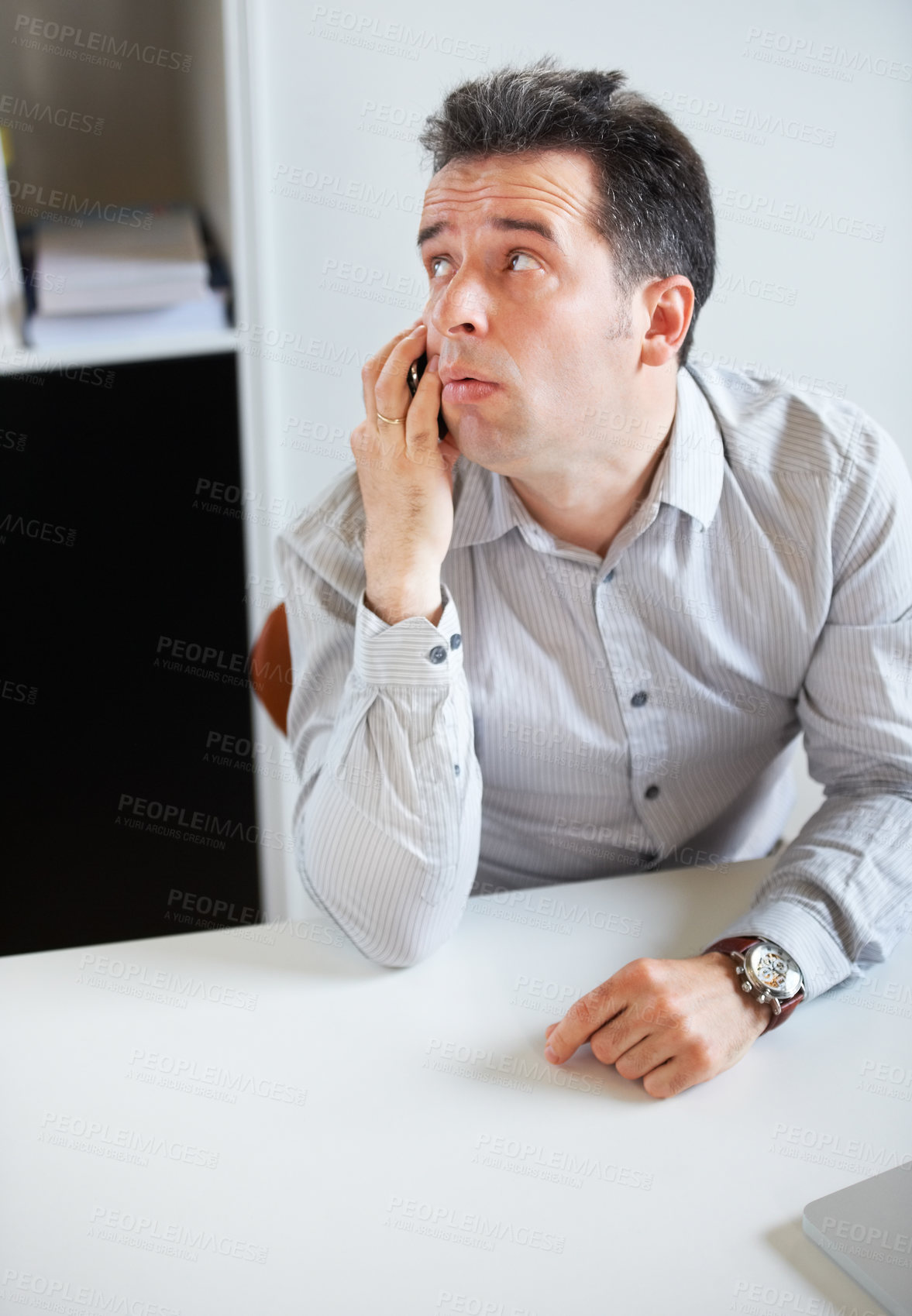 Buy stock photo Phone call, thinking or waiting with a business man sitting at his desk in the office for work. Time, contact and communication with an impatient young employee talking on his mobile in the workplace