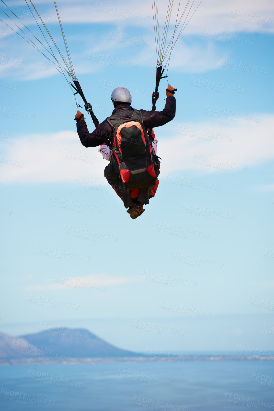 Buy stock photo People, paragliding and freedom in sky, ocean and extreme sport with back for fitness. Coach, partnership and person with adventure, helmet and fearless with backpack, parachute and sea with safety