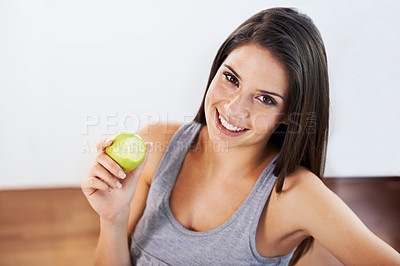 Buy stock photo Portrait, smile and apple with a woman eating fruit for health, diet or nutrition in the kitchen of her home. Food, nutritionist and a happy young model in a house for organic wellness or weight loss