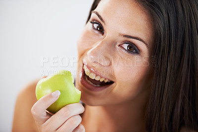 Buy stock photo Woman, portrait and eating an apple, health and wellness in bite, nutrition and vitamins for vegan. Female person, fruit and organic or natural, smile and diet in breakfast, fresh and digestion
