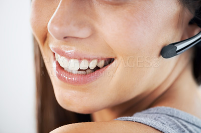 Buy stock photo Smile, mouth and headset with a customer service woman closeup in studio for support at a call center. Communication, contact us or crm and a happy young telemarketing employee with a microphone