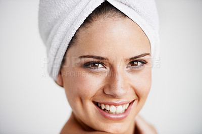 Buy stock photo Smile, beauty and woman with towel in a studio for health, wellness and natural face routine. Happy, skincare and portrait of young female model with facial dermatology treatment by gray background.
