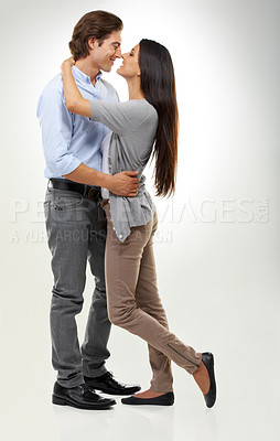 Buy stock photo Couple, hug and embracing affection for valentines day or relationship isolated against a gray studio background. Happy man and woman hugging and enjoying loving romance for the special month of love