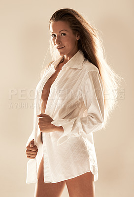 Buy stock photo Studio shot of a gorgeous woman posing in a shirt that exposes her cleavage 