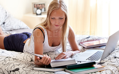 Buy stock photo Books, laptop and female student on a bed for learning, research or college homework assignment. Education, university and learner online in bedroom studying, reading or check exam schedule at home