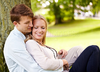 Buy stock photo Nature, relax and happy couple hug, love and cuddle in outdoor park, green garden or grass field, pitch or lawn. Summer freedom, support and romantic man, woman or marriage people hugging on ground