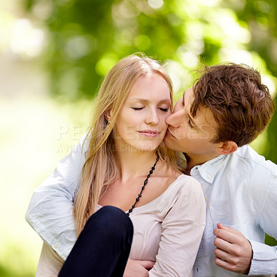 Buy stock photo Young couple sitting together in the park