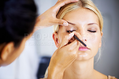Buy stock photo Face, makeup and stylist with brush for woman in cosmetics, beauty or application of eyeshadow color. Eyes, powder or hands on model for cosmetic, mascara and skincare for creative transformation