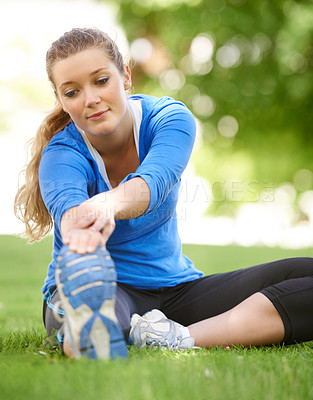 Buy stock photo Woman, hands and stretching legs on grass, park or outdoor at start of exercise or workout. Female, athlete or person in warm up with shoes on feet for fitness, preparation or healthy routine
