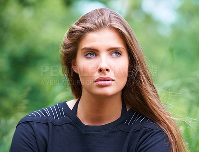 Buy stock photo A gorgeous young woman looking away thoughtfully outdoors
