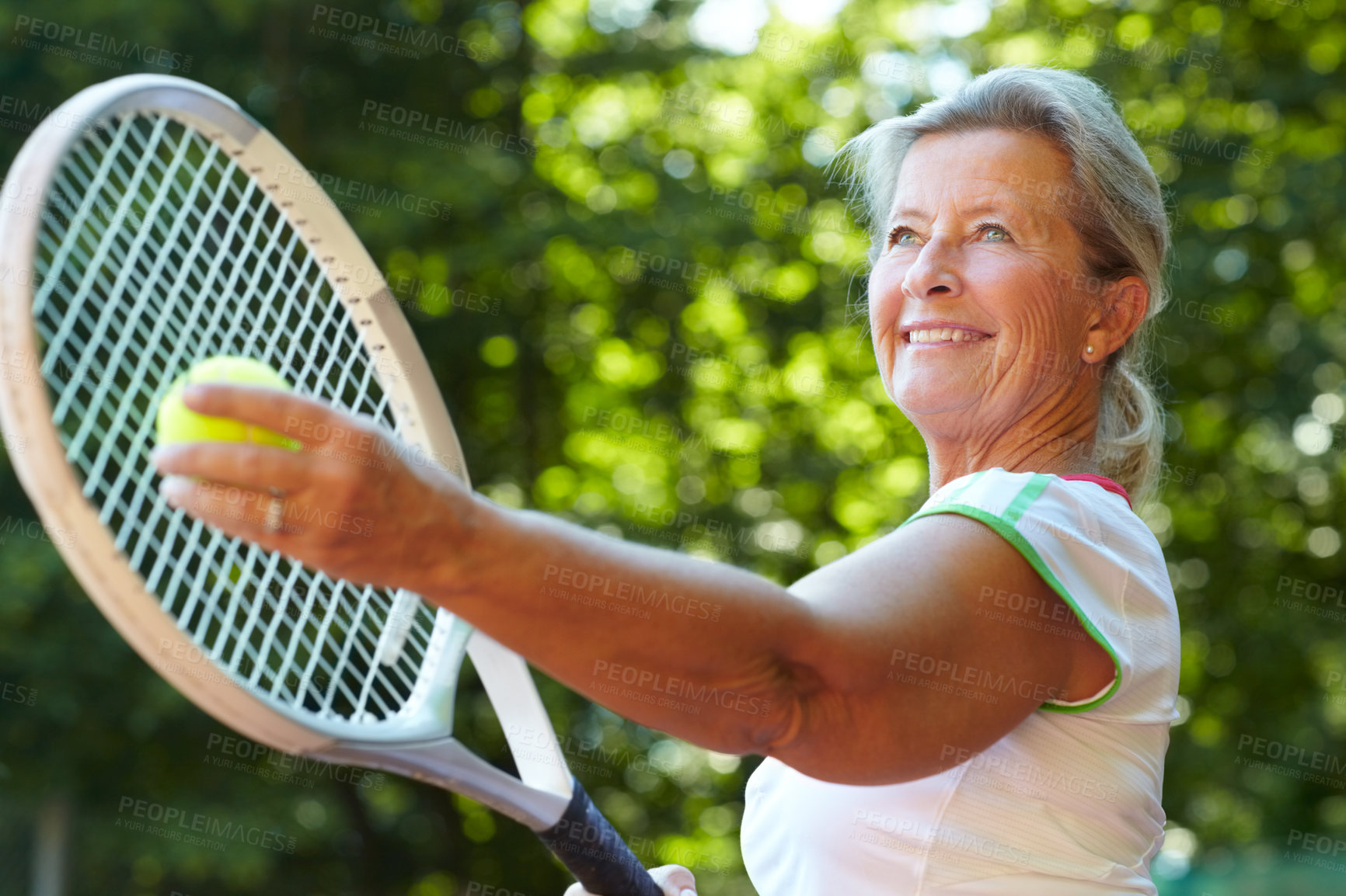 Buy stock photo Senior woman preparing to serve a tennis ball