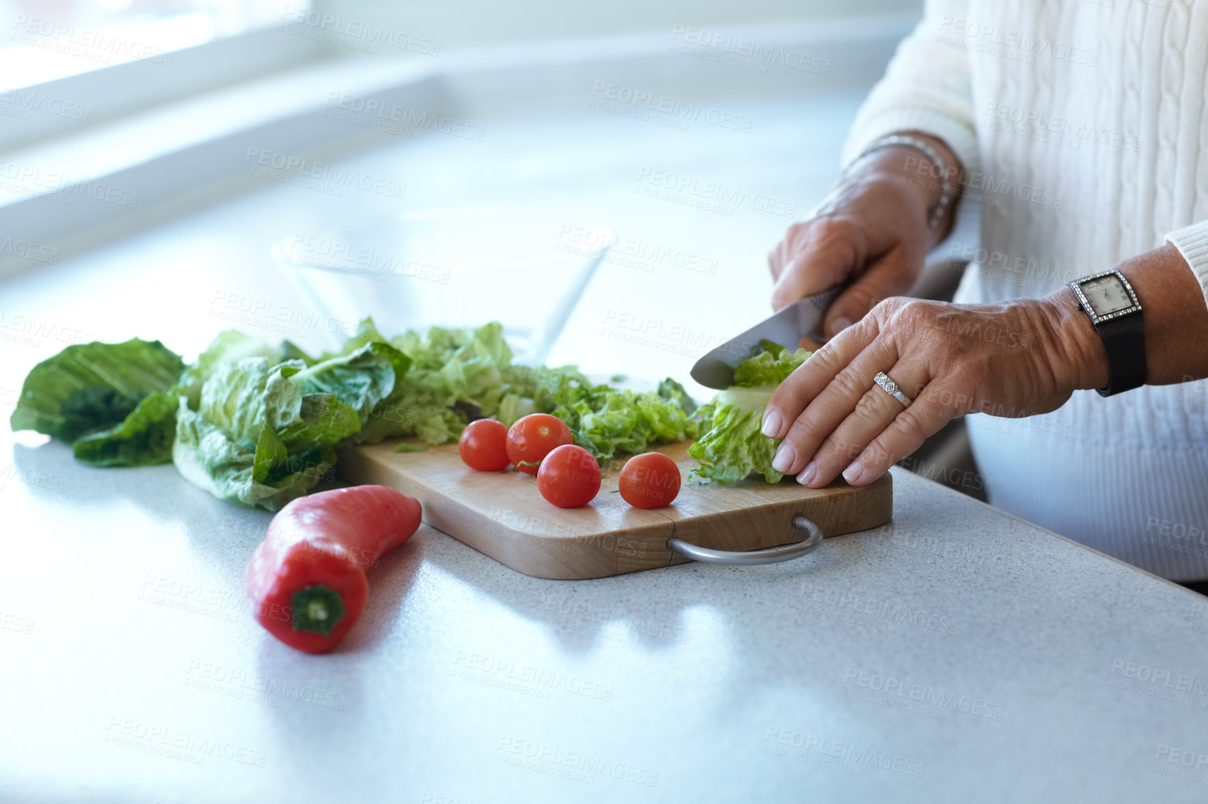 Buy stock photo Hands on chopping board, vegetables and knife on table in kitchen cooking organic food. Woman cutting plants on counter, prepare lettuce and tomatoes, pepper and nutrition for healthy diet in home