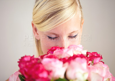 Buy stock photo Smelling, romance and woman with flowers as a gift isolated on a grey studio background. Surprise, romantic and girl with a bouquet of roses for valentines day with a natural, floral present