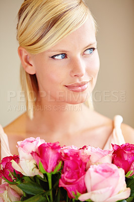 Buy stock photo Cropped shot of a young woman holding a bunch of pink roses
