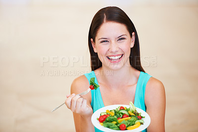 Buy stock photo Portrait of a happy young woman enjoying a salad