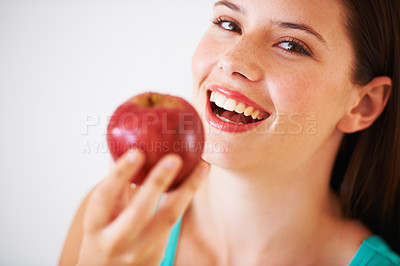 Buy stock photo Portrait of a beautiful young woman eating an apple