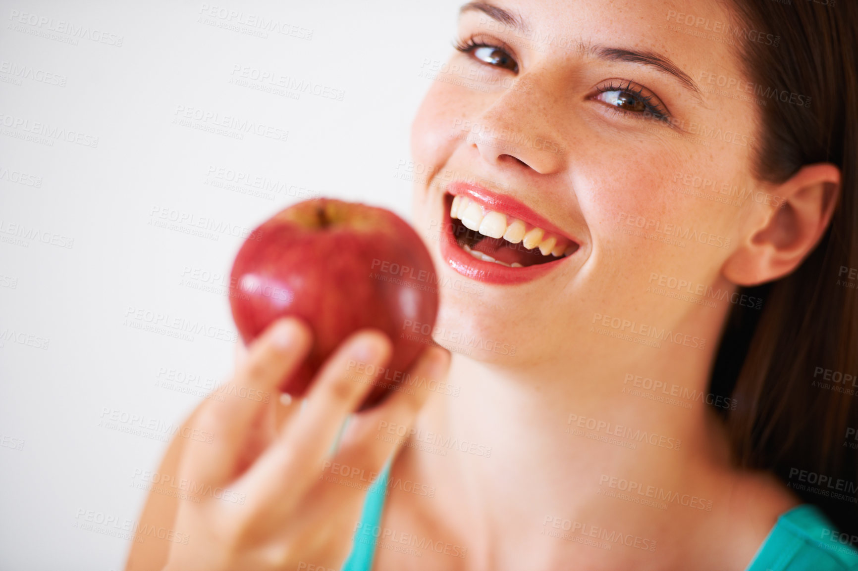 Buy stock photo Portrait of a beautiful young woman eating an apple