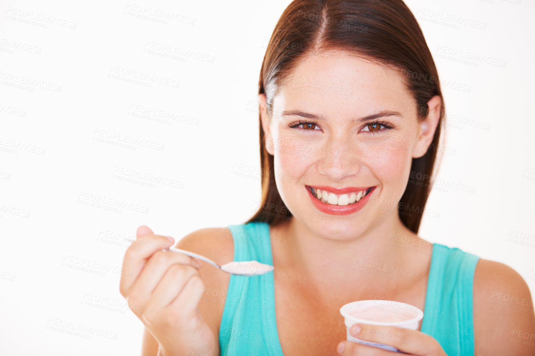 Buy stock photo Portrait of a beautiful young woman eating a yoghurt